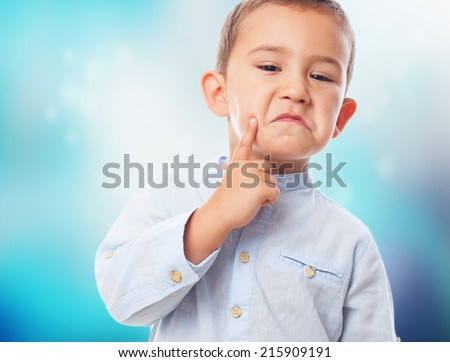 portrait of a little boy with pensive gesture