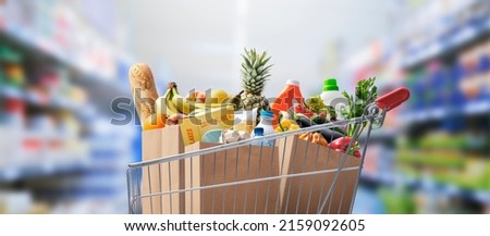 Shopping cart full of groceries at the supermarket Royalty-Free Stock Photo #2159092605