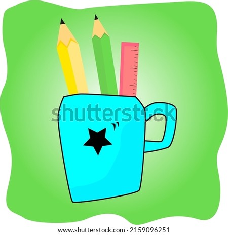 blue mug with black star image. blue mug on a green background. blue mug with stationery.