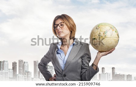 portrait of a business young woman holding a globe