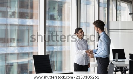 Indian woman shake hand company boss hr manager after successful job interview, client and manager handshake make deal feel satisfied. Multiracial workmates meet in office talk express respect concept Royalty-Free Stock Photo #2159105261