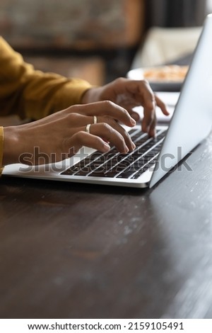 Close up cropped vertical view African female hands typing on laptop keyboard, student prepare task, studying on-line. Correspondence to client use e-mail, workflow use modern tech, freelance concept Royalty-Free Stock Photo #2159105491