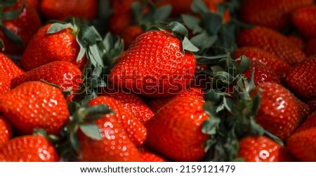Close-up of a selective focus of ripe strawberries on the counter. Strawberries are sold in boxes as a healthy food. Top view of delicious, fresh, juicy strawberries, just picked. Juicy berries. Royalty-Free Stock Photo #2159121479