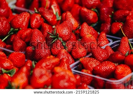 Close-up of a selective focus of ripe strawberries on the counter. Strawberries are sold in boxes as a healthy food. Top view of delicious, fresh, juicy strawberries, just picked. Juicy berries. Royalty-Free Stock Photo #2159121825