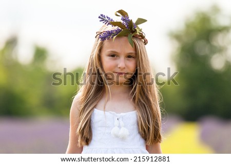Pretty young girl playing in lavender field