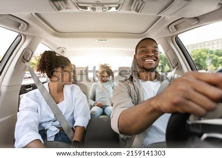 Happy African American Family Driving New Automobile Having Ride In City, Enjoying Road Trip. Parents And Daughter Spending Vacation Traveling By Car. Auto Purchase And Rent. Selective Focus Royalty-Free Stock Photo #2159141303