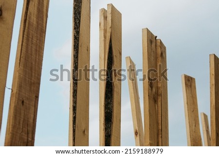 Wooden construction boards on the background of the sky selective focus. Building materials in the form of wooden boards prepared for use.