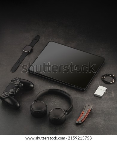 Devices mockup template. Video accessories on a dark structural background. Tablet, headphones, phone, lens, video camera and watch
