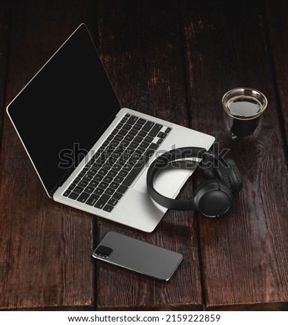 Workspace mockup template  on wood structural background. Musician composer workplace with headphones, laptop, phone and cup of coffee
