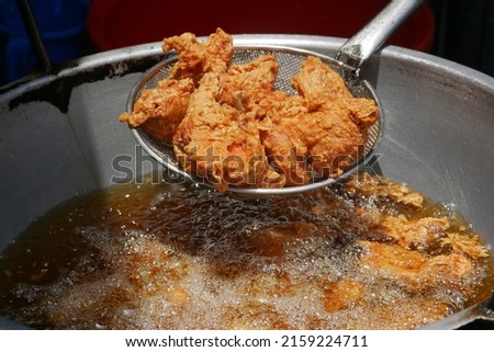  Fried chicken in deep fry outdoor  Royalty-Free Stock Photo #2159224711