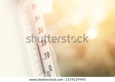 Outdoor thermometer outside the window of the house is close-up. Thermometer scale with plus air temperature. A device for determining the air temperature outside the house. Selective focus Royalty-Free Stock Photo #2159229445