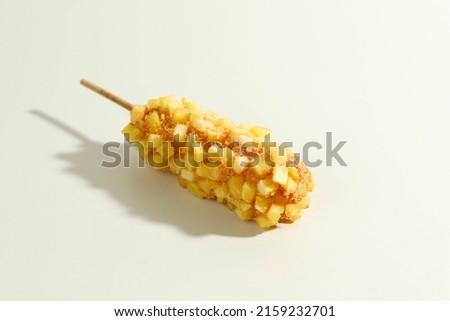 Delicious Crunchy Korean Style Chunky Potato Corn Dogs with Batter and Fried Potatoes. Isolated on Cream Background with Copy Space for Text Royalty-Free Stock Photo #2159232701