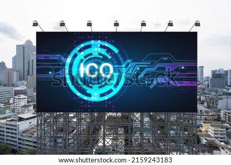 ICO hologram icon on billboard over panorama city view of Bangkok at day time. The hub of blockchain projects in Southeast Asia. The concept of initial coin offering, decentralized finance