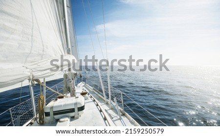 White yacht sailing on a sunny day. Top down view from the deck to the bow and sails. Waves and water splashes. Clear blue sky. North sea, Norway. Transportation, sport, recreation theme Royalty-Free Stock Photo #2159250579