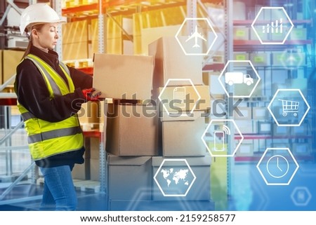Logistics center worker. Girl in work uniform with boxes. Logistic symbols next to woman. Logistics center employee unloads boxes. Concept of international fulfillment. International warehouse Royalty-Free Stock Photo #2159258577