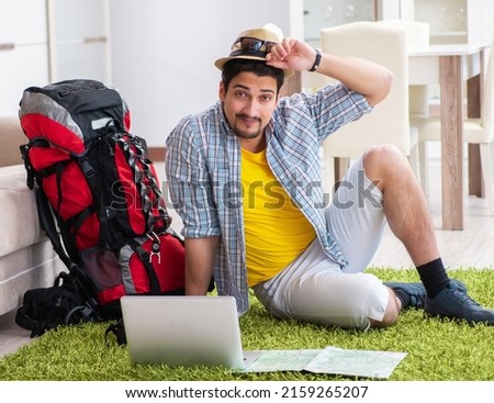 Young man planning his travel online Royalty-Free Stock Photo #2159265207
