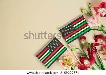 creative background for Juneteenth day with Black Liberation African American flags and bright flowers