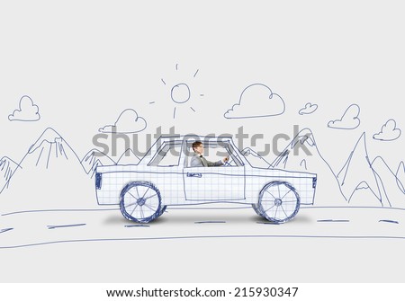 Young man driving car made of sheet of paper