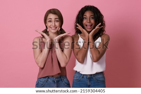 Happy loving lesbian couple good time together isolated on pink background. LGBT concept.