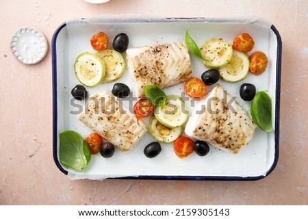 Roasted cod with olives and tomatoes