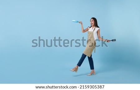 Entrepreneur Asian professional chief ready to cook, Chef holding spatula and frying pan isolated copy space on blue background. Royalty-Free Stock Photo #2159305387