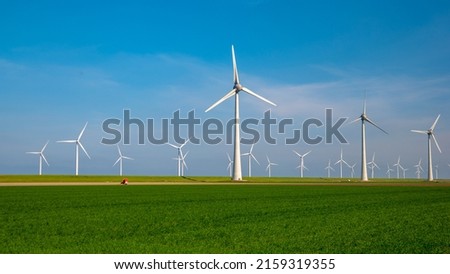 Windmill farm in the ocean Westermeerwind park, windmills isolated at sea on a beautiful bright day Netherlands Flevoland Noordoostpolder. Huge windmill turbines Royalty-Free Stock Photo #2159319355