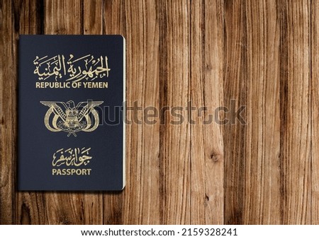 Yemeni passport on a wooden background ,A Yemeni passport is a government document used by citizens of Yemen for international travel