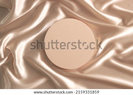 Geometric platform podium on pastel wave silk satin fabric background. Blank minimal cylinder form mock up background for beauty cosmetic product presentation. Top view, copy space Royalty-Free Stock Photo #2159331859