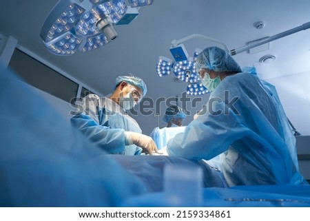 Surgical team making operation in sterile medical room Royalty-Free Stock Photo #2159334861