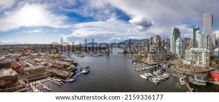 Modern Cityscape on the West Coast Pacific Ocean. Downtown City Skyline, Burrard Bridge and Granville Island. False Creek, Vancouver, British Columbia, Canada. Aerial Panorama
