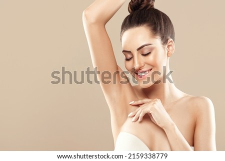 Beauty portrait. Armpit epilation, lacer hair removal. Young woman showing clean underarms. Royalty-Free Stock Photo #2159338779