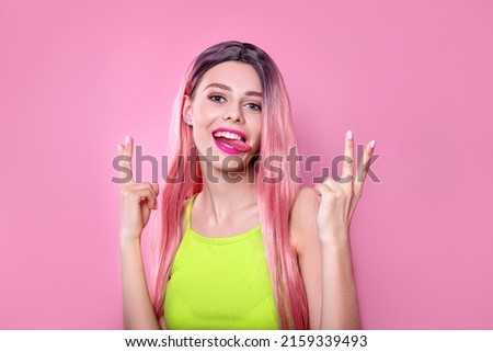 Close-up portrait of woman with bright long colored pink hair and pink make-up on studio background. Professional coloring Royalty-Free Stock Photo #2159339493