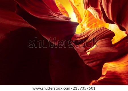 Beautiful wide angle view of amazing and colorful sandstone formations in famous Antelope Canyon on a sunny day with yellow sky the old town of Page at Lake Powell, American Southwest, Arizona, USA
