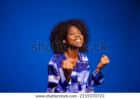 beautiful lady listen to music excited isolated over blue background