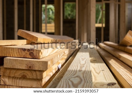 Pile of wood lumber planks stacked at residential construction site Royalty-Free Stock Photo #2159393057