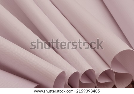 rolls of light purple flexible fabric. pastel color fabric samples with fibrous texture. banner material, digital printing industry