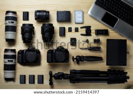 Flat lay composition with equipment for professional photographer on the table.