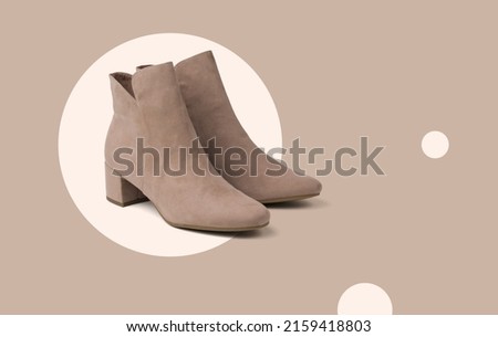 Stylish beige women's suede boots on an abstract beige background. Minimal concept of women's shoes. Royalty-Free Stock Photo #2159418803