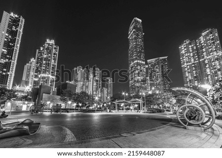 Public park and skyscraper in downtown district of Hong Kong city at night