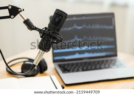 Condenser microphone in recording home studio. Content creator working with laptop host streaming radio podcast interview conversation at home broadcast studio recording waveform voice over radio