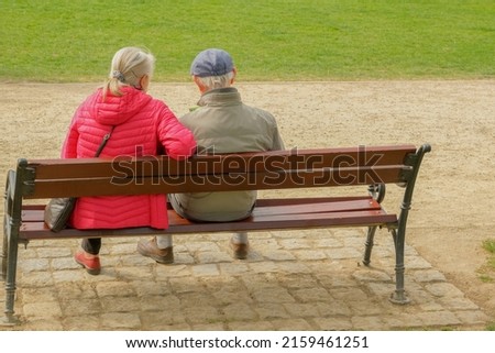 Oldies at the Park . elderly couple sitting on a park bench Royalty-Free Stock Photo #2159461251