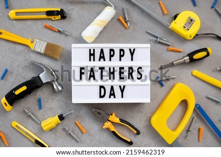 Father's Day lightbox message with tools for repair saw nippers hammer . top view flat lay. I love dad.