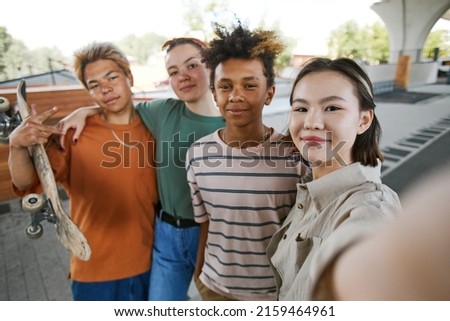 POV shot of diverse group of teens taking selfie photo outdoors in urban area and smiling at camera Royalty-Free Stock Photo #2159464961
