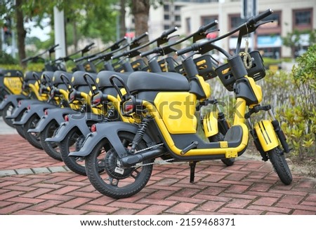 mopeds stand in a row for rent. Royalty-Free Stock Photo #2159468371