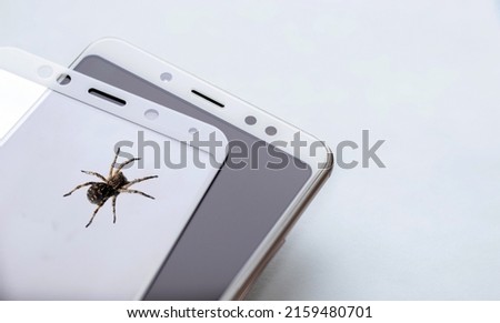 maintenance and repairing smartphones. glass screen protector bove mobile phone and a spider, replace,installation concept. concept. photoshopped photography, space for text, mock up