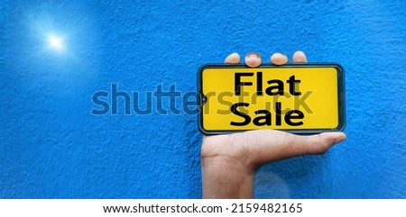 Flat Sale word on smart phone screen isolated on blue background with copy space for text.