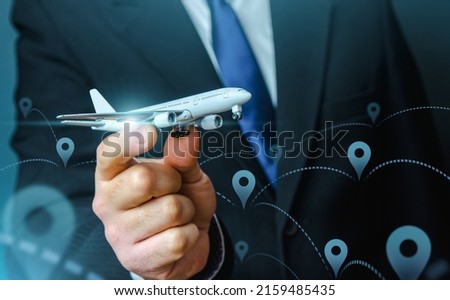A plane taking off in the hands of a businessman and a pin location symbol. Business tourism. Organization of air traffic. Business class flights. Support financial program for civil aviation Royalty-Free Stock Photo #2159485435