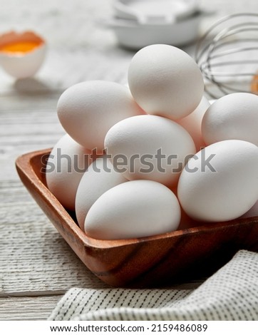 White eggs in wooden bowl close-up Royalty-Free Stock Photo #2159486089