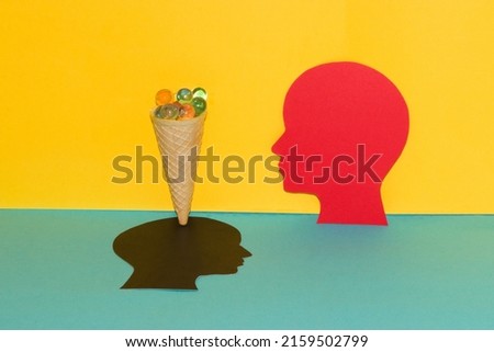 red paper head looks at the ice cream cone which is the brain of the black head 3d design, creative summer concept, abstract yellow-blue background