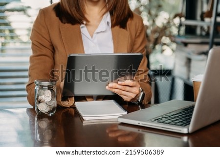 Businessman hand using laptop and tablet with social network diagram on desk as concept 
